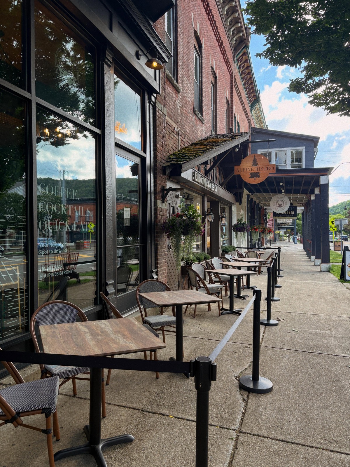 Alpine Bistro storefront with sidewalk cafe tables on Main Street in Ellicottville