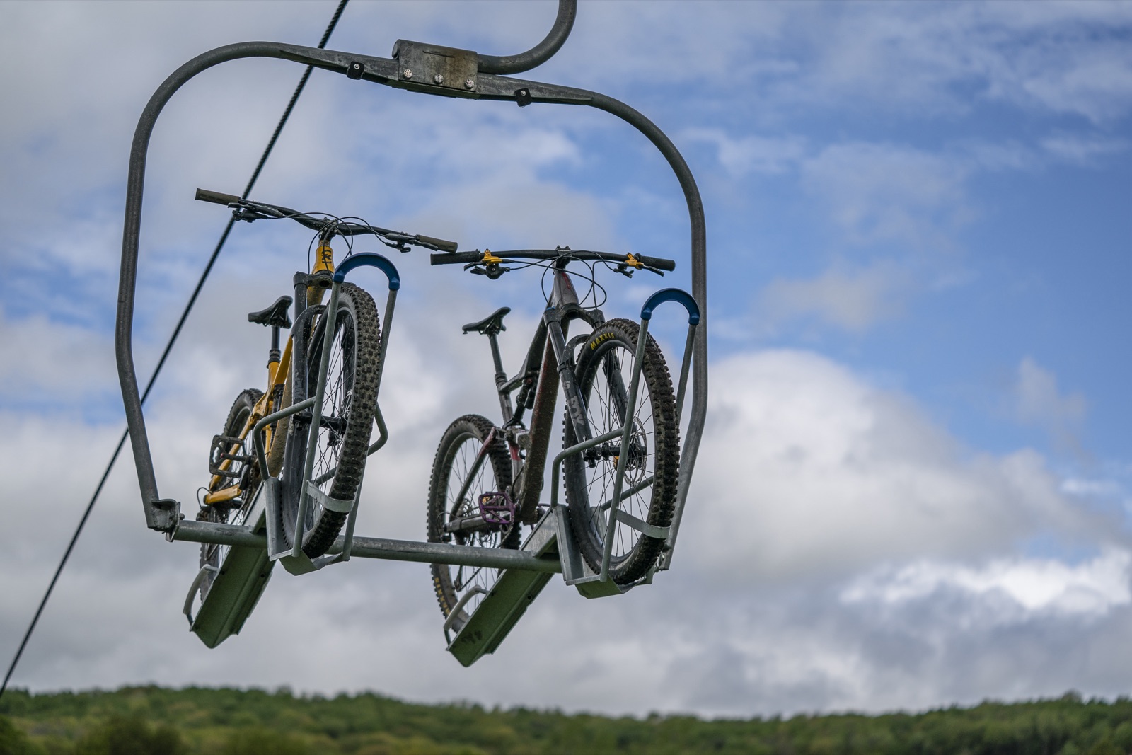 Two mountain bikes loaded on a Sunset Chair bike carrier at the HoliMont Bike Park