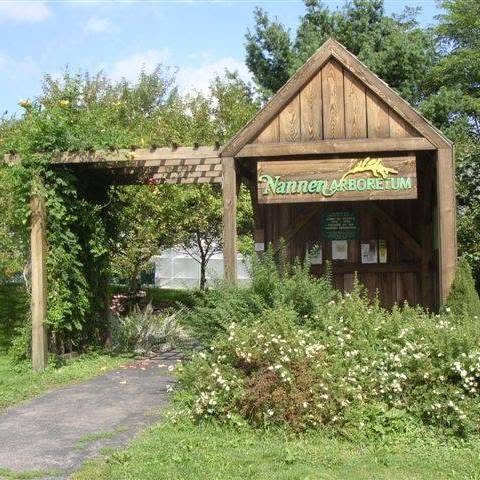 Wooden entrance sign and gardens at the Nannen Arboretum in Ellicottville
