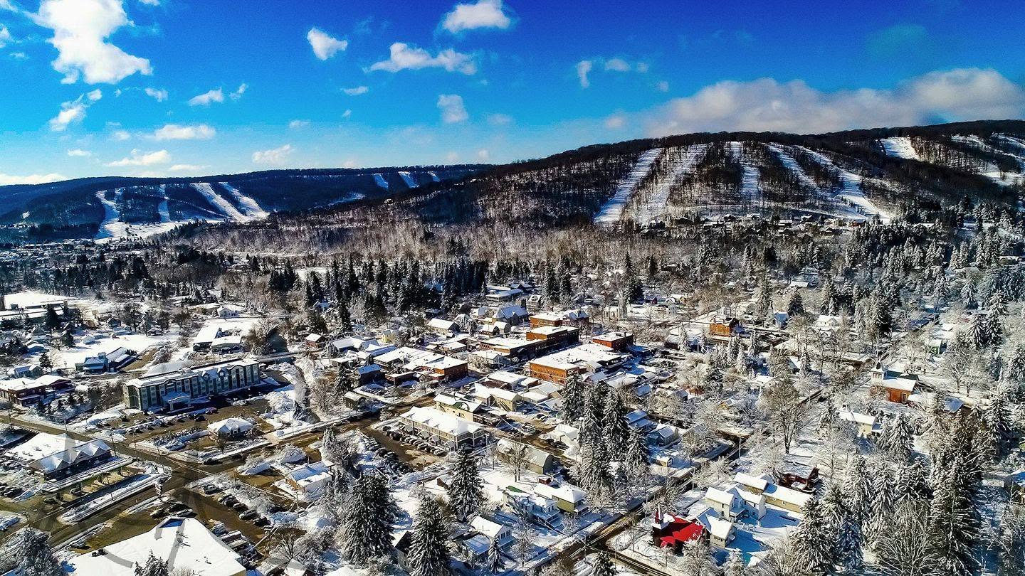 Aerial of the village of Ellicottville with ski slopes behind